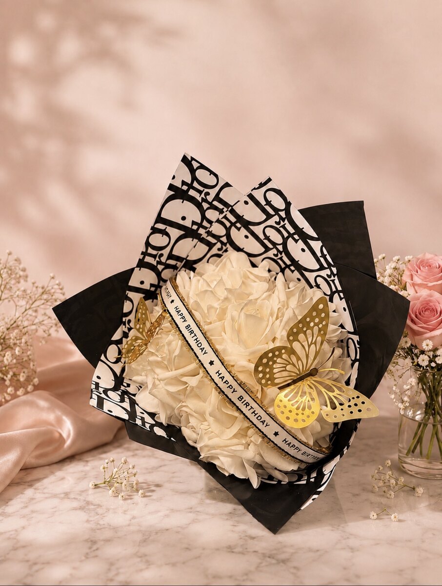 White luxury birthday bouquet with designer-inspired wrapping