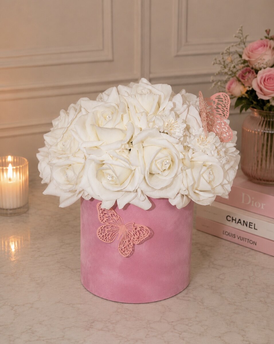 White roses in a pink velvet flower box